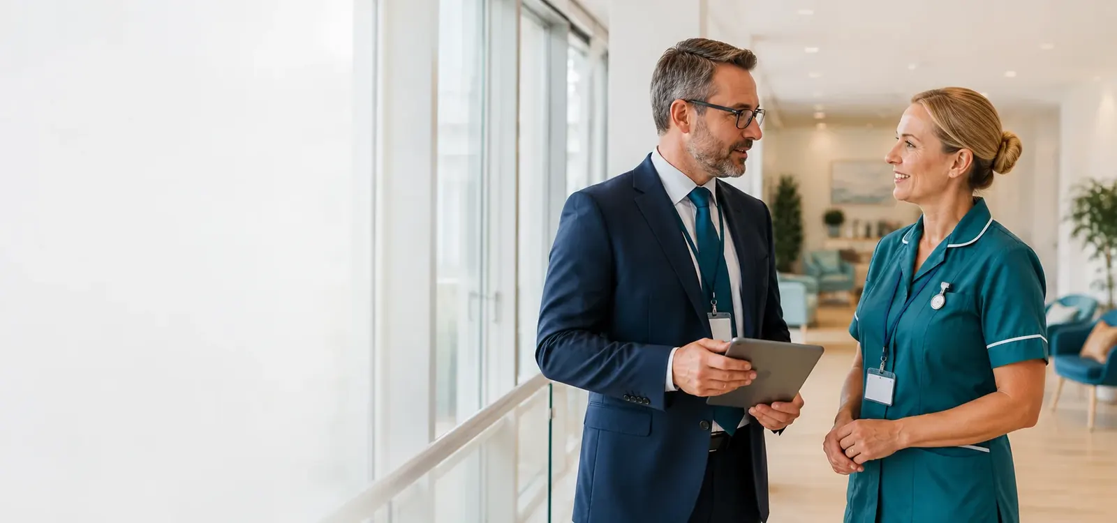 Two healthcare professionals walking together in a bright clinical setting